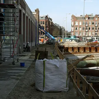 A building under renovation beside an open excavation