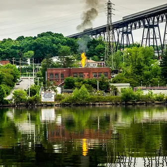 A natural gas vent pipe standing among trees