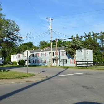 Low brick apartment buildings along a residential street